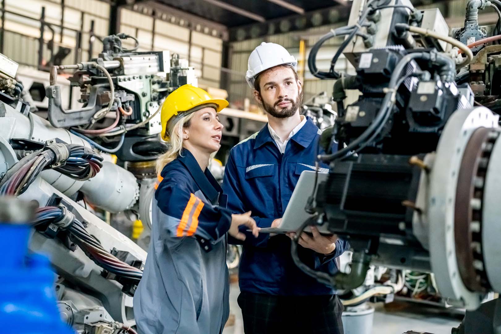 Automotive workers inspecting automotive parts in a factory