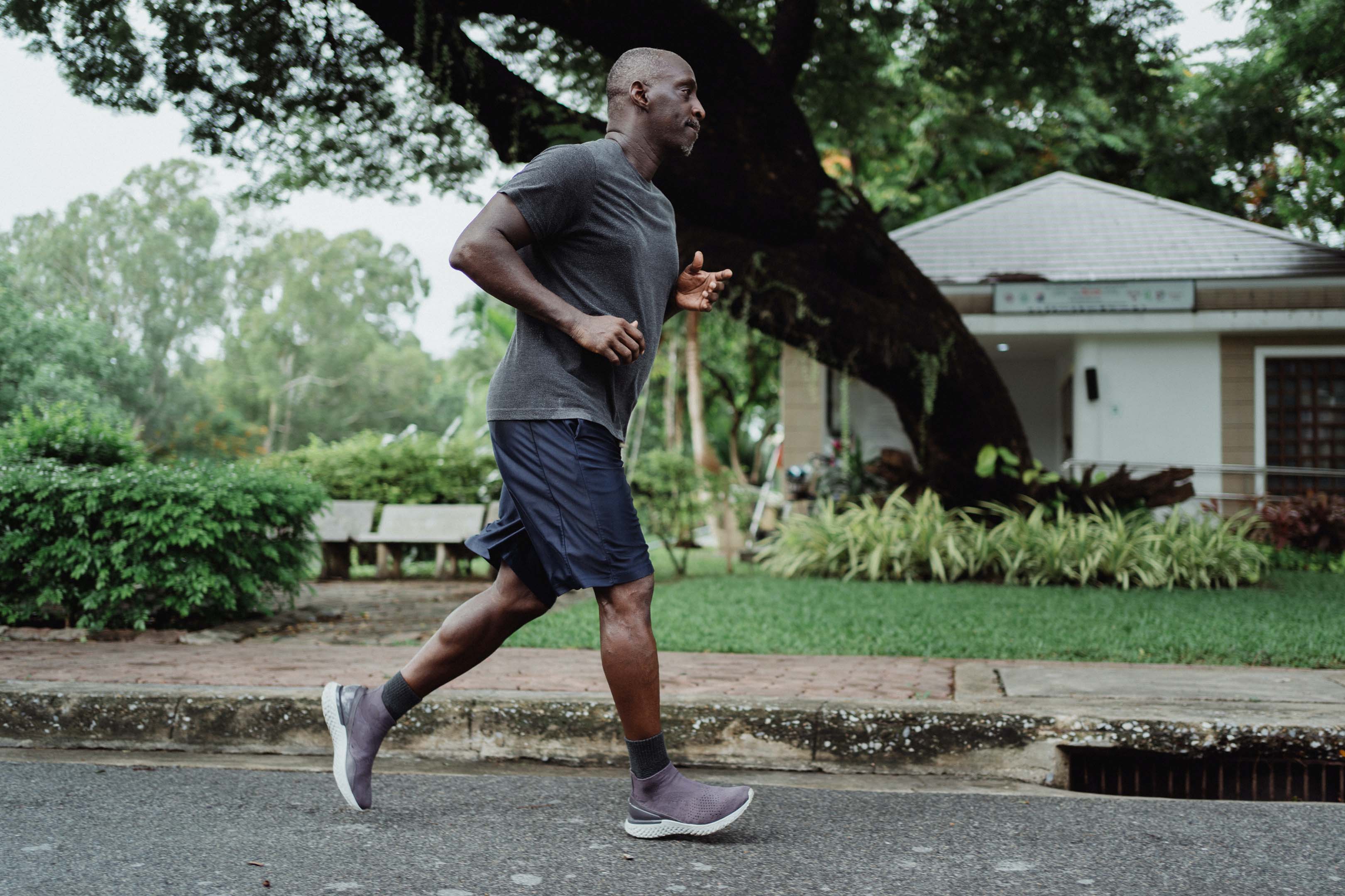 Person running down a street to boost their physical health