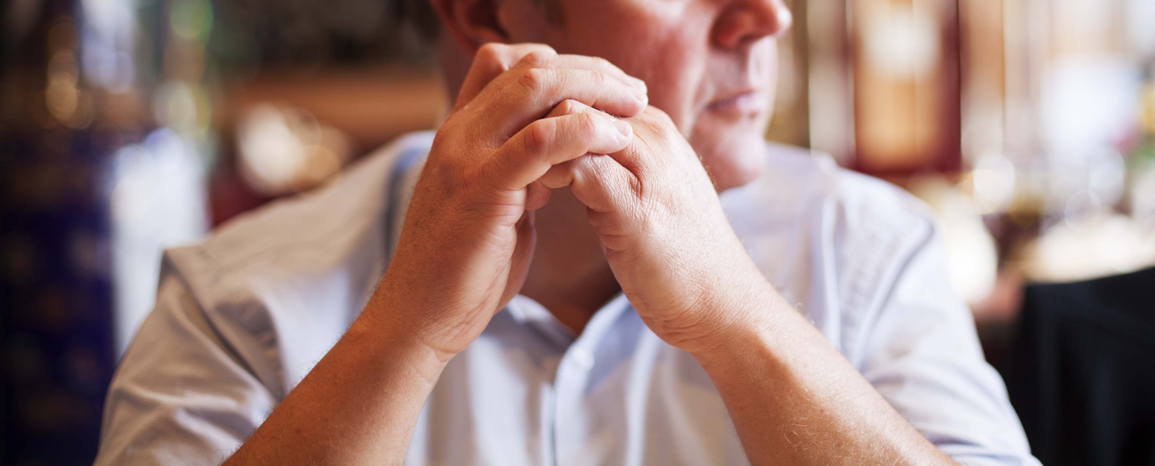 Person anxious while sat down. Understand what redundancy is, what it could mean for you financially, mentally and the impact on family life