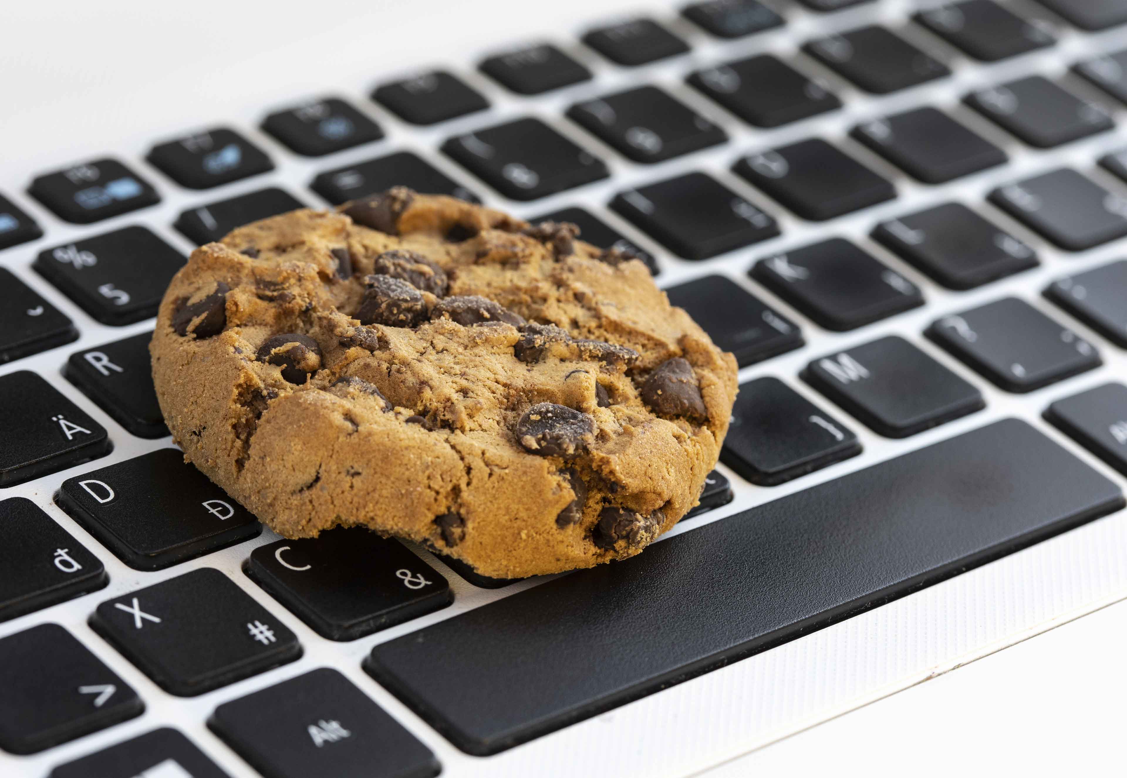 Chocolate chip cookie sat on a keyboard
