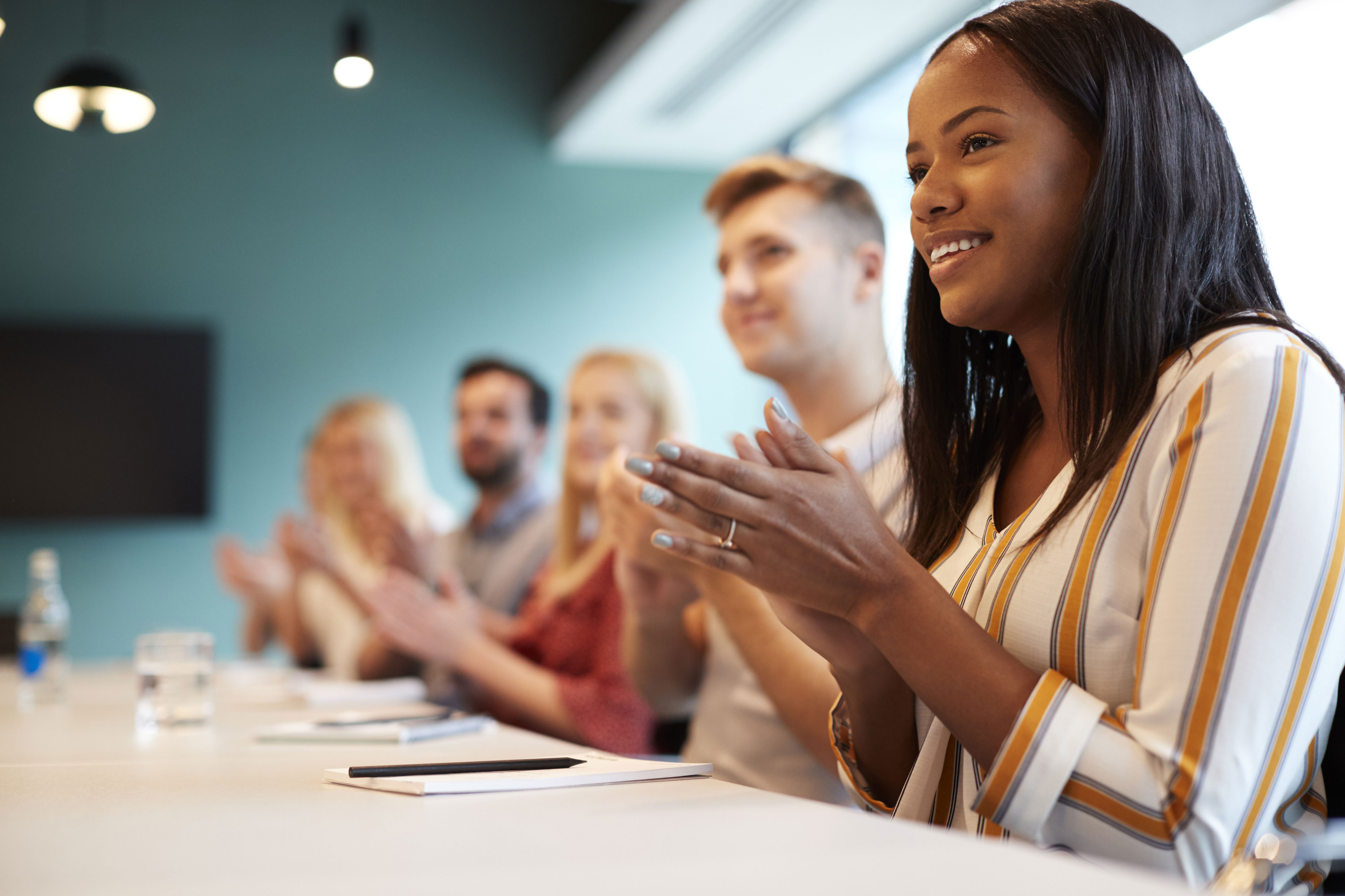 Group of young jobseekers applauding a presentation