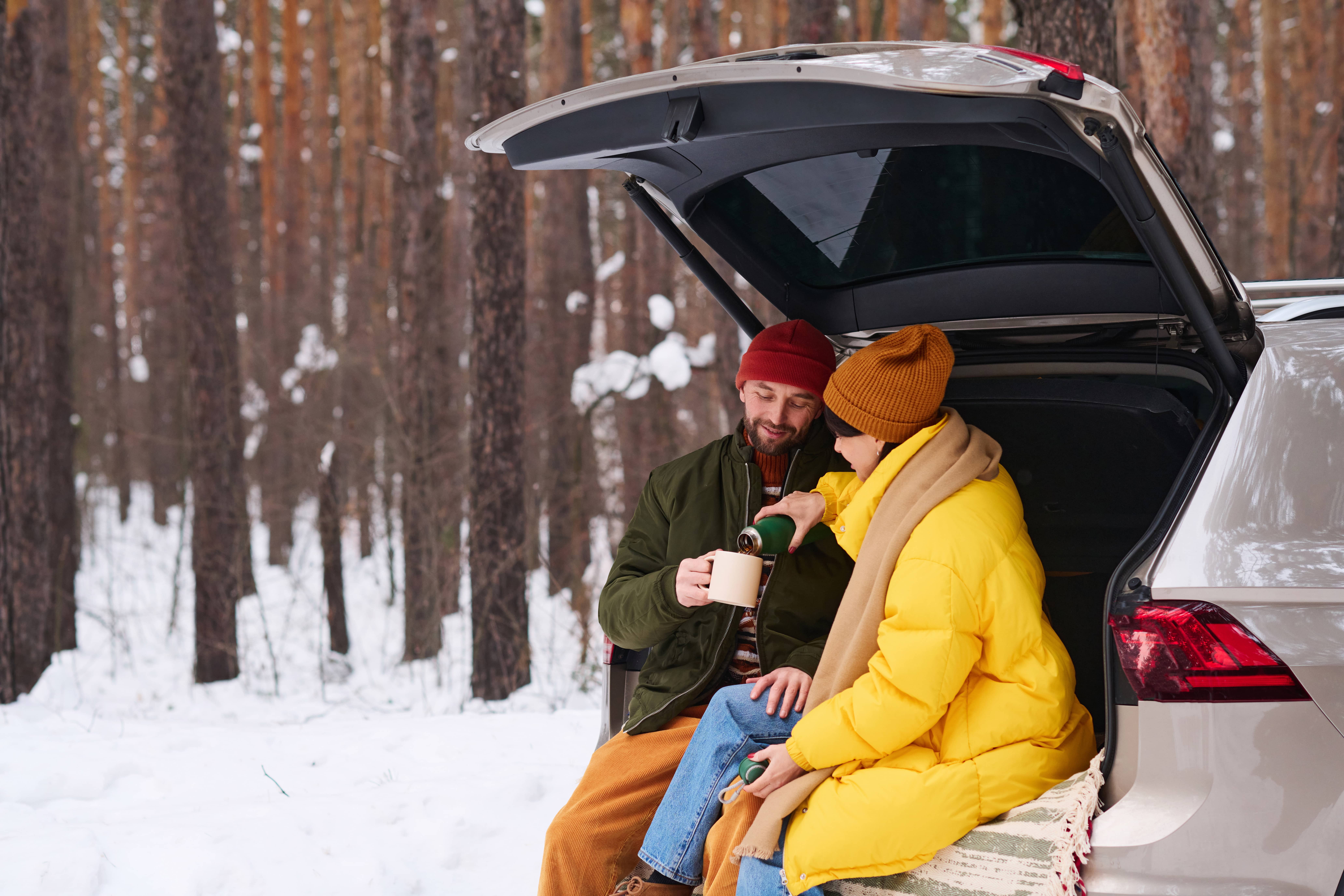 man and woman in the car in snow