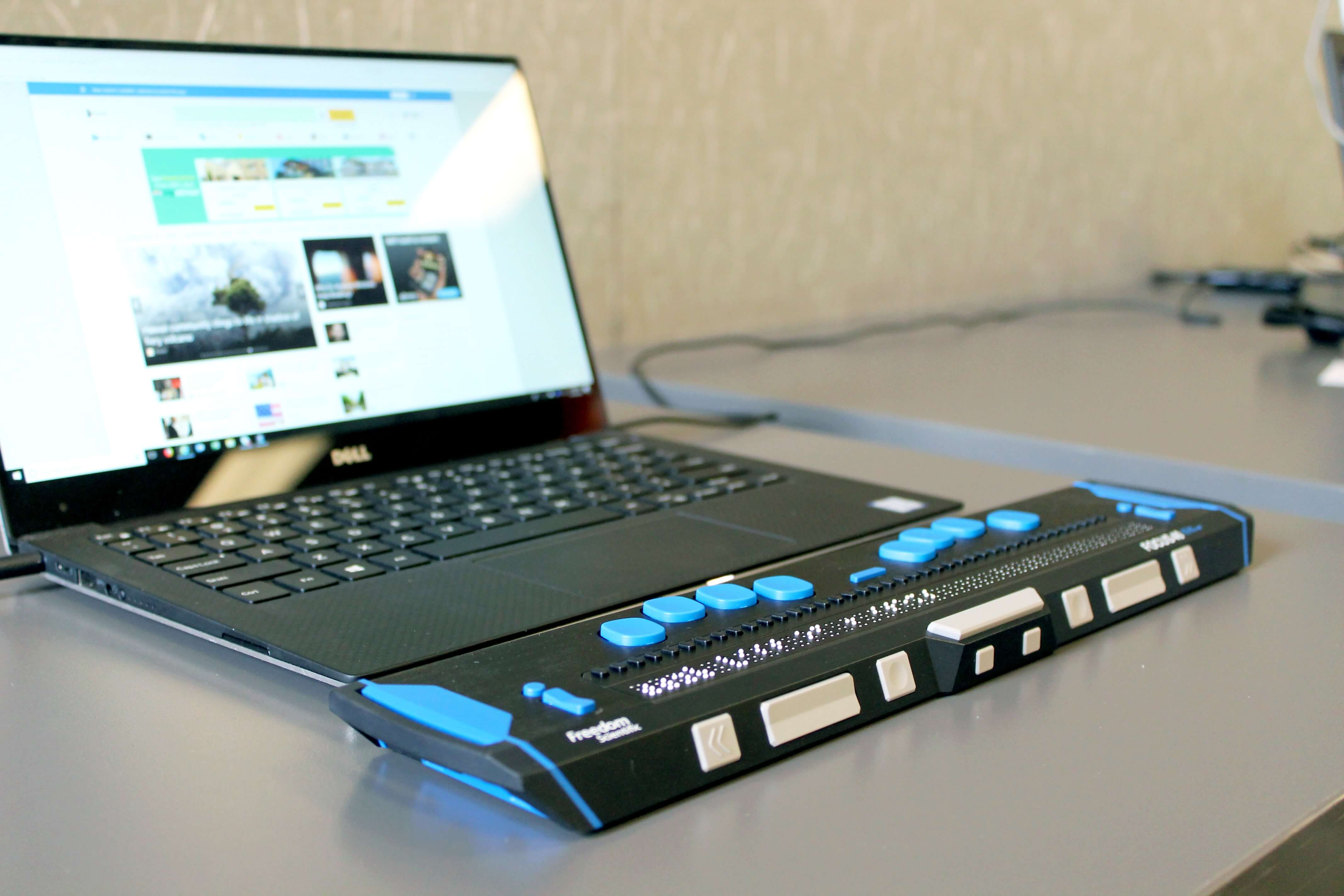 Image of a laptop with a connected accessibility device to help navigate a website